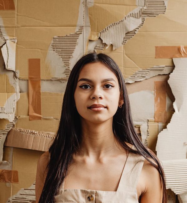 Portrait of a smiling, confident woman against a neutral background.